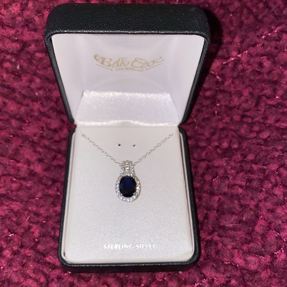 Sterling silver blue sapphire necklace with surrounding stones like diamond